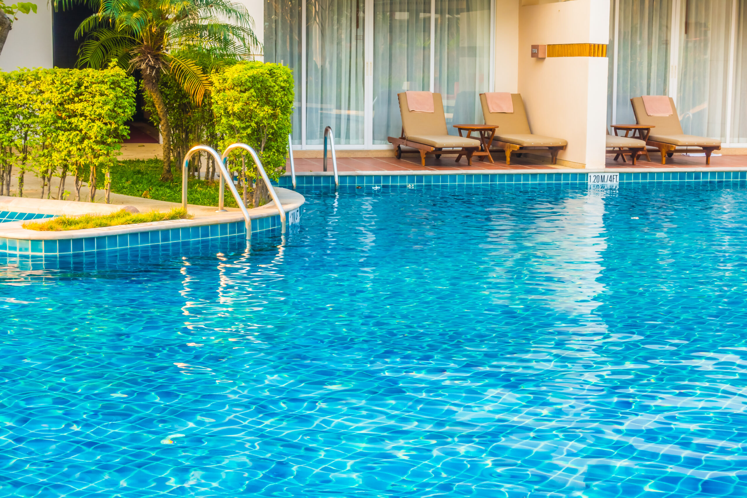 Empty Umbrella and chair around swimming pool in hotel resort